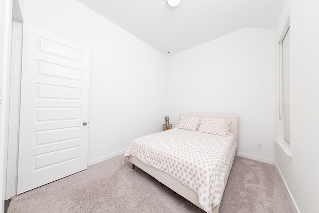 bedroom featuring vaulted ceiling, baseboards, and carpet floors