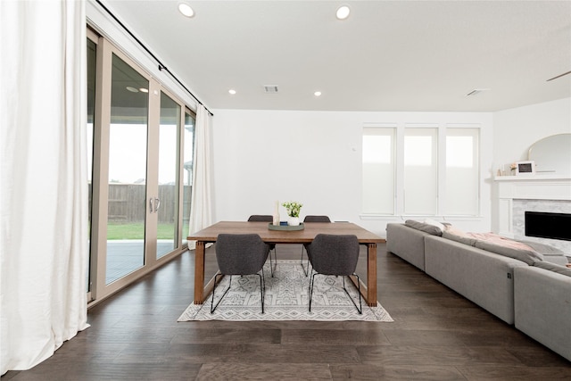 dining space featuring french doors, visible vents, recessed lighting, a fireplace, and dark wood finished floors