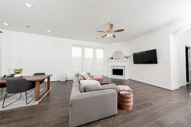 living room with recessed lighting, a fireplace, ceiling fan, dark wood finished floors, and baseboards