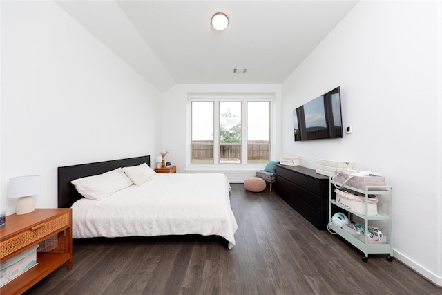 bedroom with baseboards, vaulted ceiling, visible vents, and dark wood-type flooring