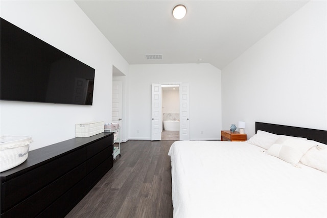 bedroom featuring ensuite bath, dark wood-type flooring, baseboards, and visible vents