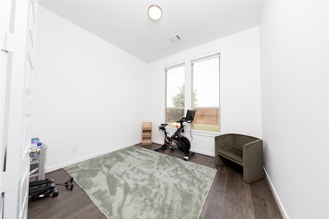 home office with baseboards, lofted ceiling, visible vents, and dark wood-type flooring