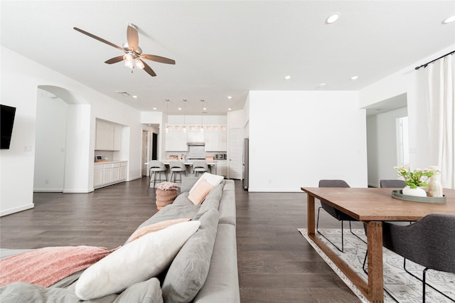 living area featuring baseboards, recessed lighting, ceiling fan, and dark wood-style floors