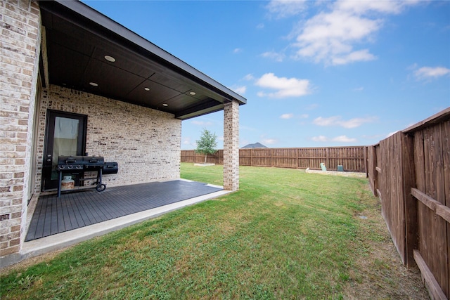 view of yard with a fenced backyard and a deck