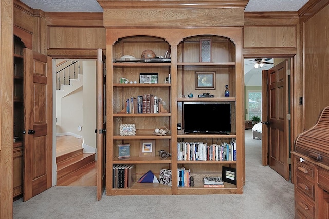 interior details with a ceiling fan and carpet
