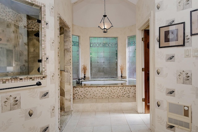 bathroom with lofted ceiling, heating unit, tiled shower, a garden tub, and tile patterned floors
