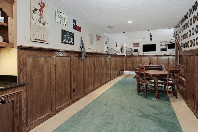 dining room featuring a wainscoted wall, recessed lighting, and a textured ceiling
