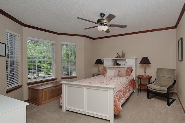 bedroom with ornamental molding, light carpet, ceiling fan, and a textured ceiling