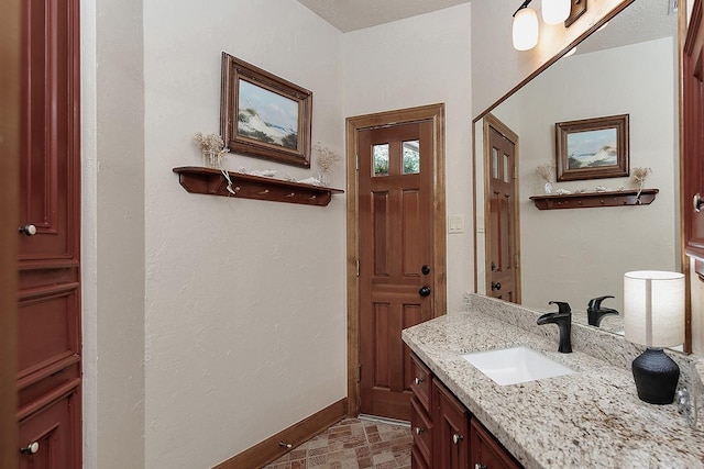 bathroom with baseboards and vanity
