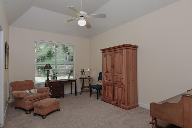 sitting room featuring light colored carpet, baseboards, and a ceiling fan
