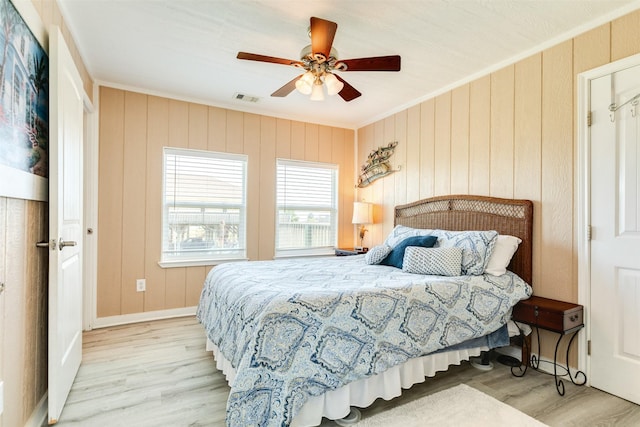 13022 Coronado Dr, Freeport, TX 77541 - bedroom featuring ornamental molding, baseboards, visible vents, and wood finished floors