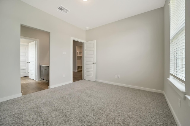 2563 Newport Breeze Dr, Katy, TX 77493 - unfurnished bedroom featuring carpet flooring, baseboards, and a walk in closet