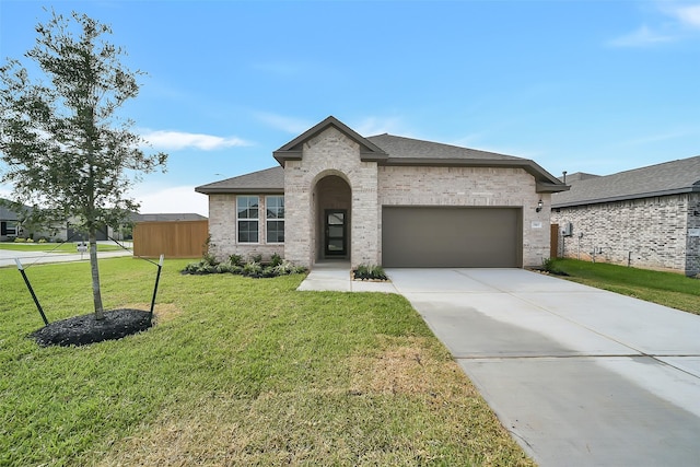 2563 Newport Breeze Dr, Katy, TX 77493 - french provincial home with an attached garage, a front yard, driveway, and brick siding