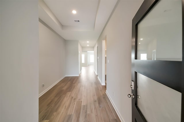 2563 Newport Breeze Dr, Katy, TX 77493 - corridor with wood finished floors, baseboards, recessed lighting, and a tray ceiling