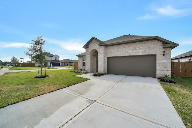 2563 Newport Breeze Dr, Katy, TX 77493 - view of front of home featuring brick siding, driveway, an attached garage, and a front yard