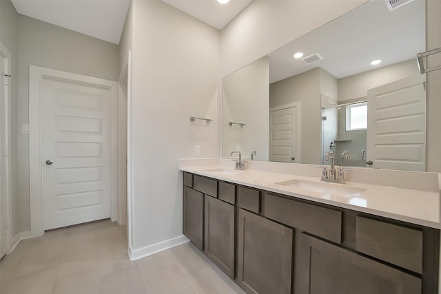 2563 Newport Breeze Dr, Katy, TX 77493 - full bath with a shower stall, baseboards, double vanity, and tile patterned floors