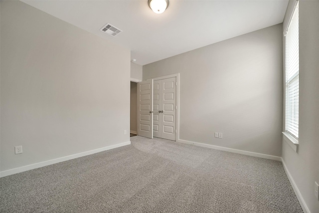 2563 Newport Breeze Dr, Katy, TX 77493 - empty room featuring plenty of natural light, light colored carpet, and baseboards