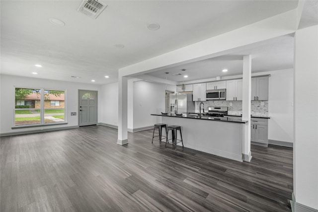 702 Pennington St, Houston, TX 77022 - kitchen with dark countertops, appliances with stainless steel finishes, open floor plan, and recessed lighting