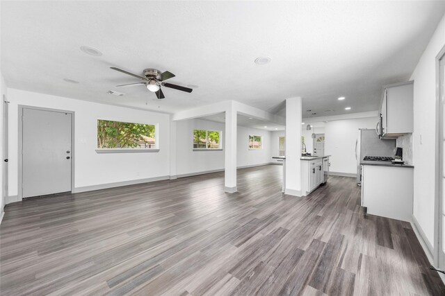 702 Pennington St, Houston, TX 77022 - unfurnished living room with baseboards, recessed lighting, ceiling fan, and wood finished floors