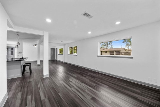 702 Pennington St, Houston, TX 77022 - unfurnished living room with recessed lighting, baseboards, ceiling fan, visible vents, and dark wood-style floors