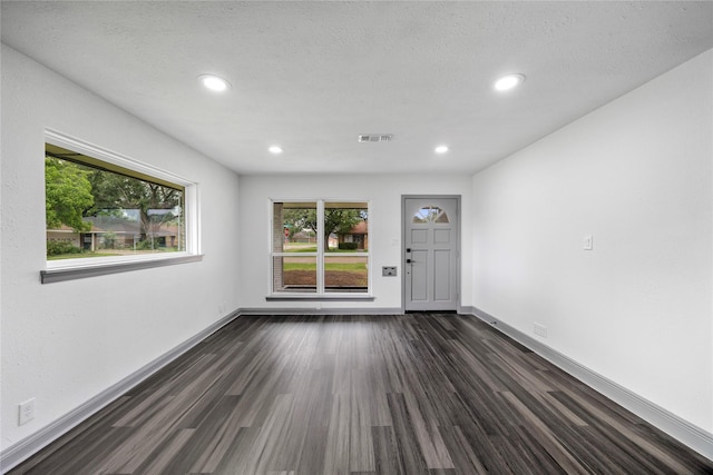 702 Pennington St, Houston, TX 77022 - spare room with baseboards, dark wood-style flooring, and recessed lighting
