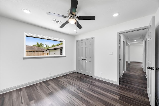 702 Pennington St, Houston, TX 77022 - unfurnished bedroom featuring a closet, attic access, baseboards, dark wood-style flooring, and visible vents