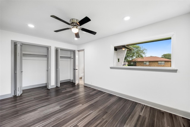 702 Pennington St, Houston, TX 77022 - unfurnished bedroom with baseboards, multiple closets, dark wood finished floors, and recessed lighting