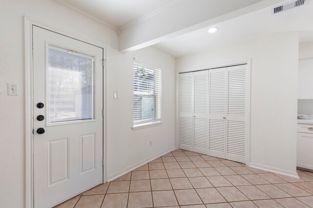 entrance foyer with visible vents, baseboards, light tile patterned flooring, and recessed lighting