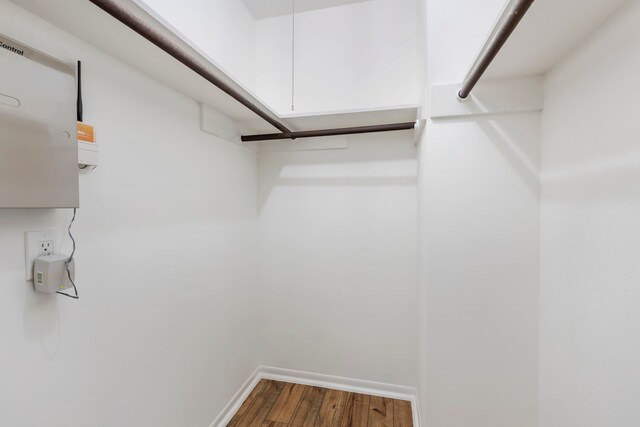 walk in closet featuring wood finished floors