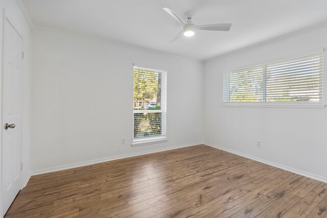 unfurnished room with a ceiling fan, ornamental molding, plenty of natural light, and hardwood / wood-style flooring