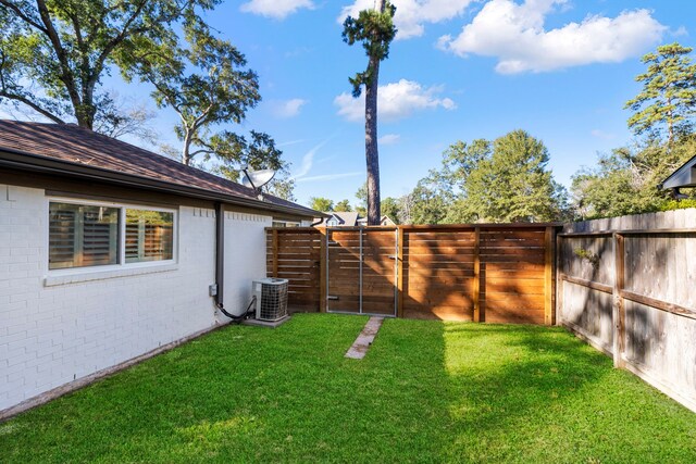 view of yard featuring central AC unit and a fenced backyard