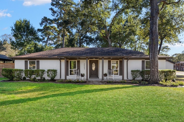 ranch-style house with a front yard and covered porch
