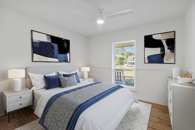 bedroom featuring wood finished floors, baseboards, and a ceiling fan
