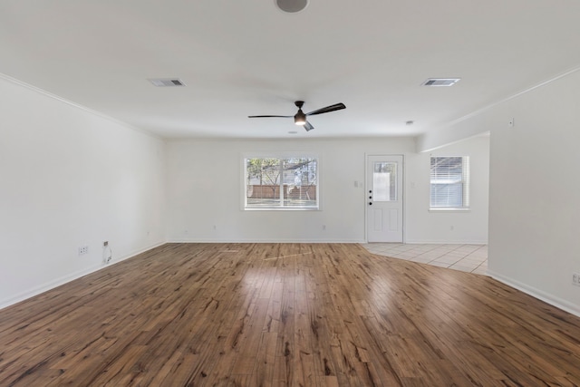 unfurnished living room with light wood-style floors, visible vents, baseboards, and a ceiling fan
