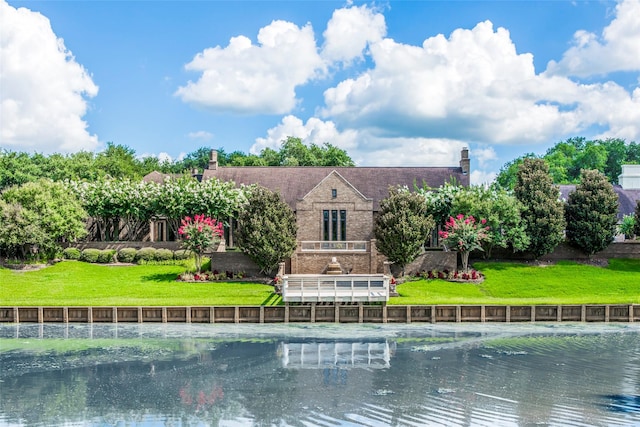rear view of property with a yard