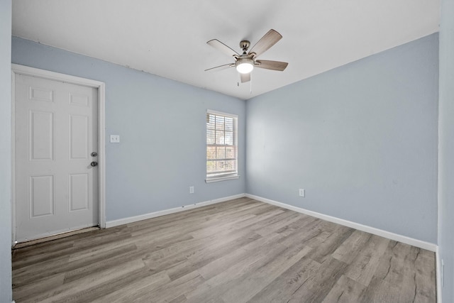 723 Frost Ave, Anahuac, TX 77514 - unfurnished room with baseboards, ceiling fan, and wood finished floors