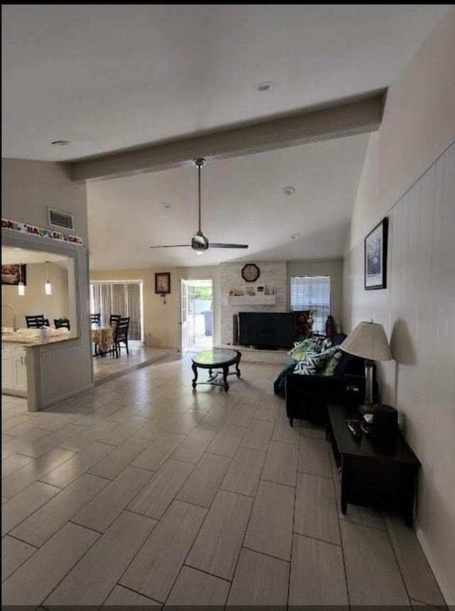 9006 Roos Rd, Houston, TX 77036 - living area with a ceiling fan, visible vents, high vaulted ceiling, beamed ceiling, and a fireplace