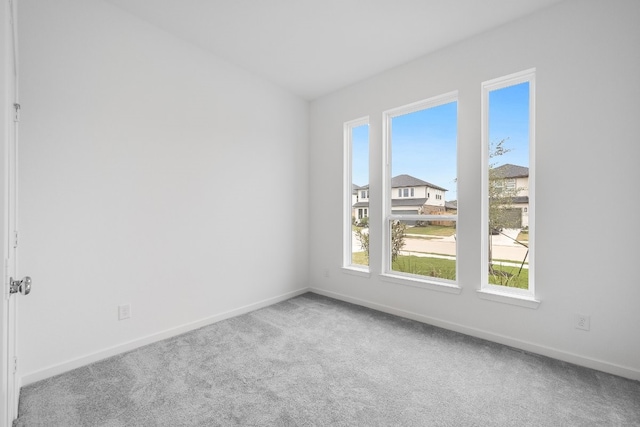 empty room with baseboards and carpet floors