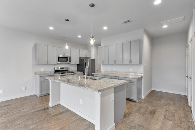 15010 Eagle Feather Ct, Houston, TX 77090 - kitchen featuring a kitchen island with sink, visible vents, recessed lighting, light wood finished floors, and appliances with stainless steel finishes