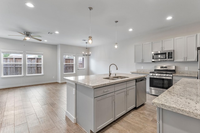 15010 Eagle Feather Ct, Houston, TX 77090 - kitchen with a sink, stainless steel appliances, a kitchen island with sink, visible vents, and light stone counters