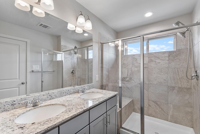 15010 Eagle Feather Ct, Houston, TX 77090 - bathroom with double vanity, visible vents, a stall shower, and a sink