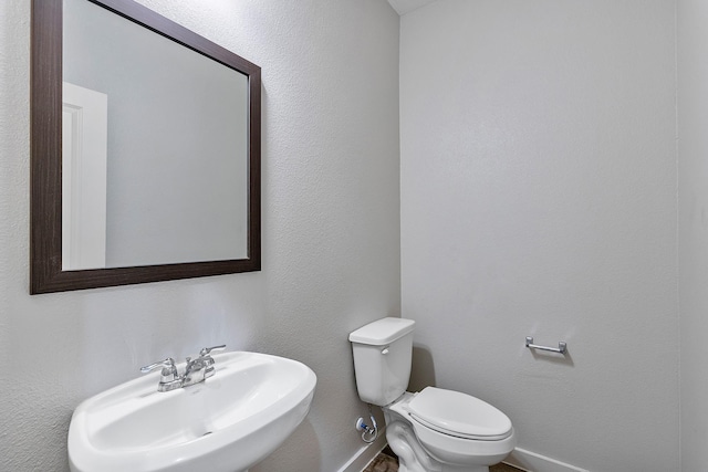 15010 Eagle Feather Ct, Houston, TX 77090 - half bathroom with baseboards, toilet, and a sink