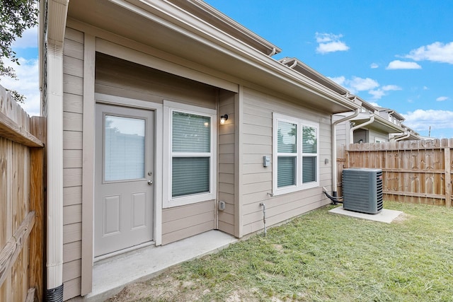 15010 Eagle Feather Ct, Houston, TX 77090 - doorway to property featuring a yard, cooling unit, and fence