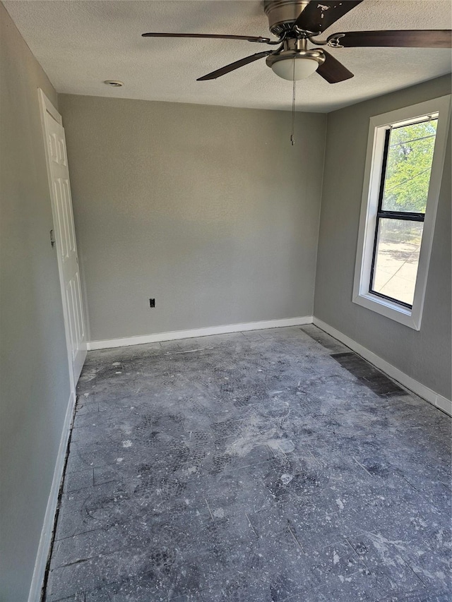 3229 Holman St Unit 4, Houston, TX 77004 - spare room with a textured ceiling, a ceiling fan, baseboards, and concrete flooring