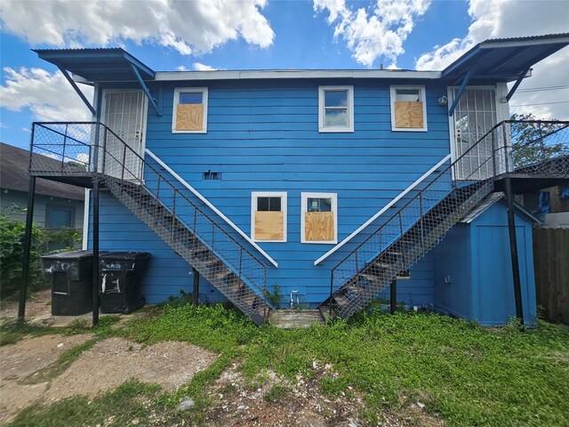3229 Holman St Unit 4, Houston, TX 77004 - back of house featuring stairway and a storage unit