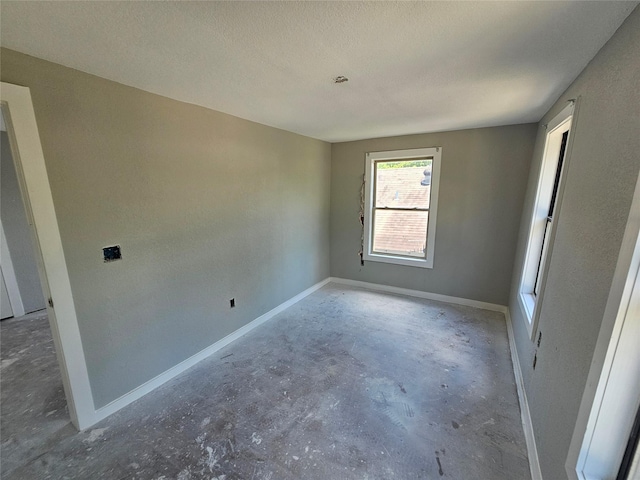3229 Holman St Unit 4, Houston, TX 77004 - unfurnished room with concrete floors, baseboards, and a textured ceiling