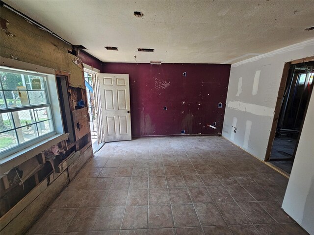 3229 Holman St Unit 4, Houston, TX 77004 - unfurnished living room with a textured ceiling and tile patterned flooring