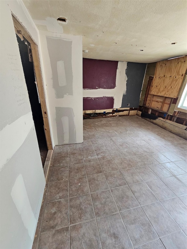 3229 Holman St Unit 4, Houston, TX 77004 - unfurnished living room featuring tile patterned floors and a textured ceiling