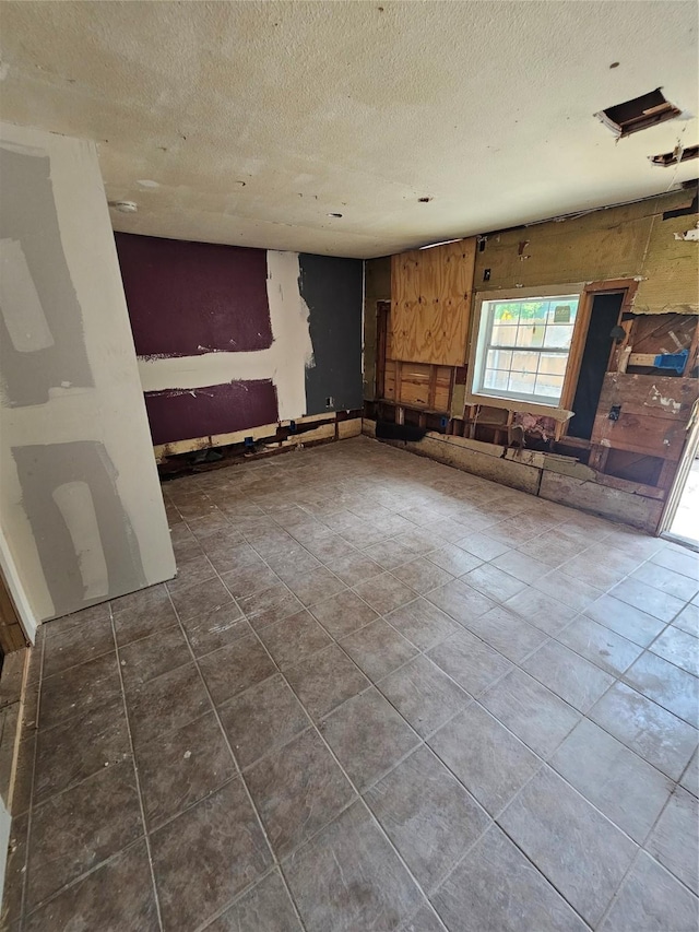 3229 Holman St Unit 4, Houston, TX 77004 - unfurnished room with a textured ceiling and dark tile patterned flooring