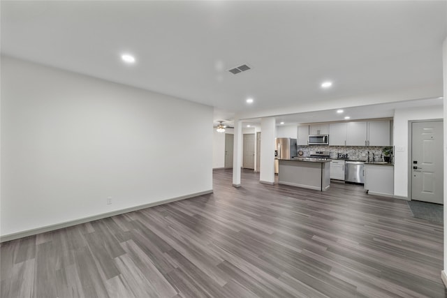 9211 Helmers St, Houston, TX 77022 - unfurnished living room with baseboards, dark wood-style floors, visible vents, and recessed lighting